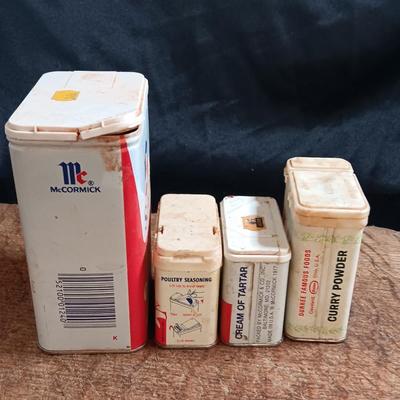 Primitive wooden cutting board with tin spice containers and aluminum salt & pepper shakers