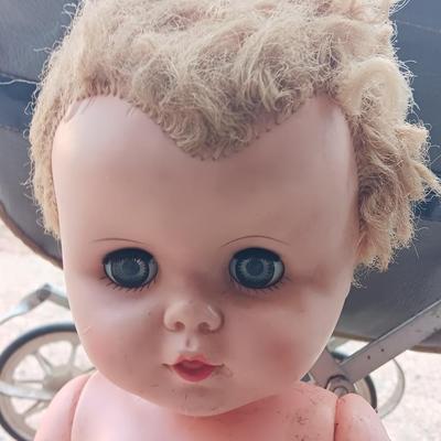 Vintage toy buggy stroller with baby doll and luggage of doll clothes