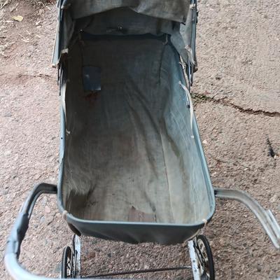Vintage toy buggy stroller with baby doll and luggage of doll clothes