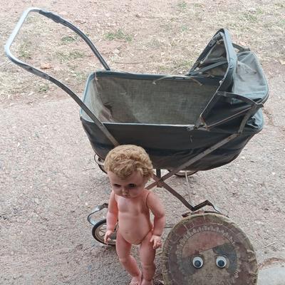 Vintage toy buggy stroller with baby doll and luggage of doll clothes