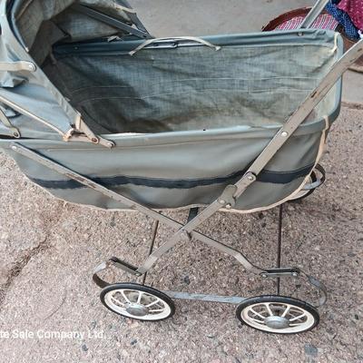 Vintage toy buggy stroller with baby doll and luggage of doll clothes