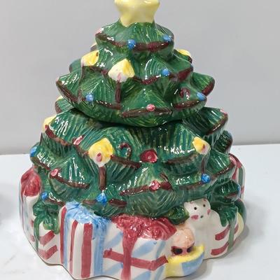 Vintage blonde angel putting star on Christmas tree figurine with tree canister