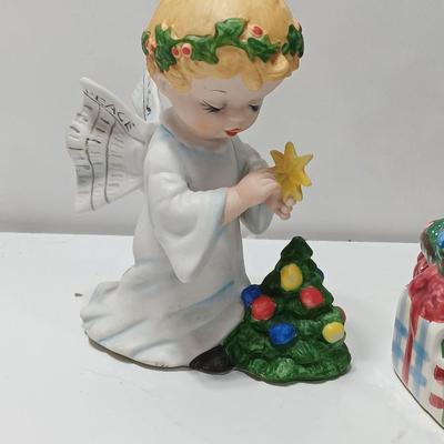 Vintage blonde angel putting star on Christmas tree figurine with tree canister
