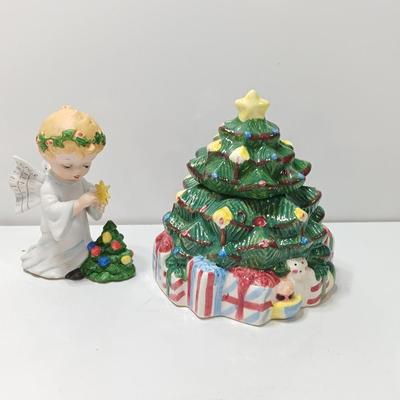 Vintage blonde angel putting star on Christmas tree figurine with tree canister