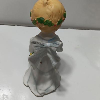 Vintage blonde angel putting star on Christmas tree figurine with tree canister