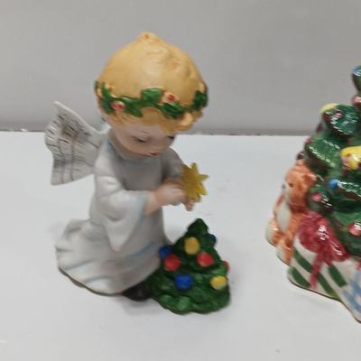 Vintage blonde angel putting star on Christmas tree figurine with tree canister