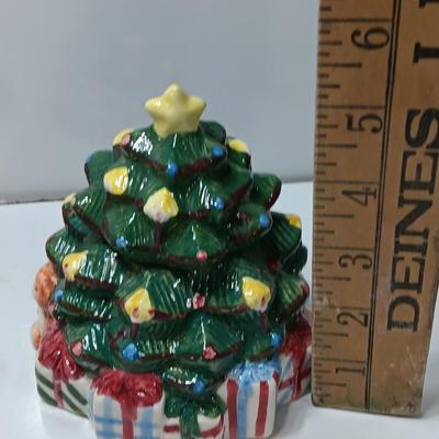 Vintage blonde angel putting star on Christmas tree figurine with tree canister