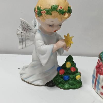 Vintage blonde angel putting star on Christmas tree figurine with tree canister