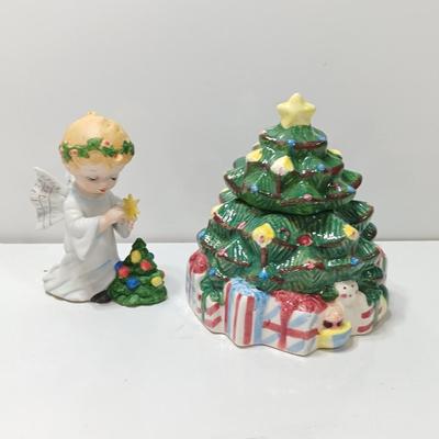 Vintage blonde angel putting star on Christmas tree figurine with tree canister