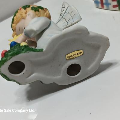 Vintage blonde angel putting star on Christmas tree figurine with tree canister