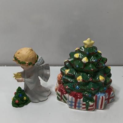 Vintage blonde angel putting star on Christmas tree figurine with tree canister