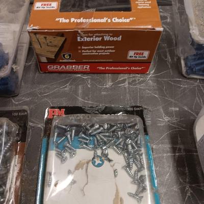 Assortment of hardware still in the boxes / tubs