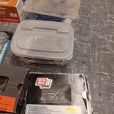 Assortment of hardware still in the boxes / tubs