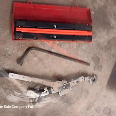 Come a long and tire iron / pry bar with orange safety triangles in a storage box