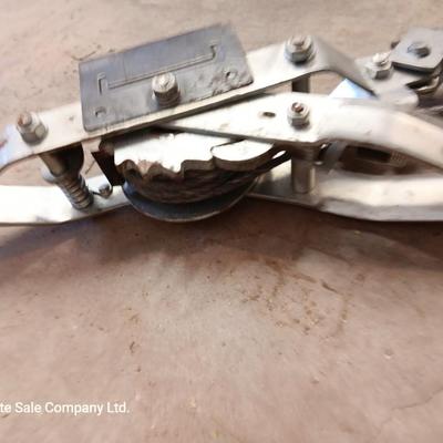 Come a long and tire iron / pry bar with orange safety triangles in a storage box