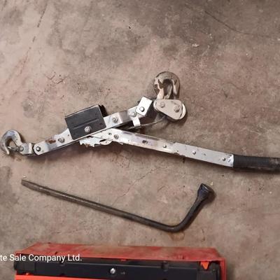 Come a long and tire iron / pry bar with orange safety triangles in a storage box