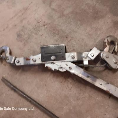 Come a long and tire iron / pry bar with orange safety triangles in a storage box