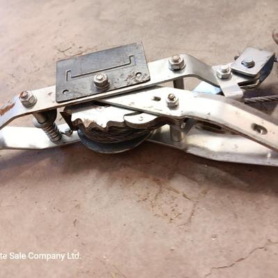 Come a long and tire iron / pry bar with orange safety triangles in a storage box