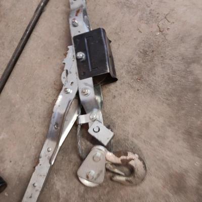 Come a long and tire iron / pry bar with orange safety triangles in a storage box