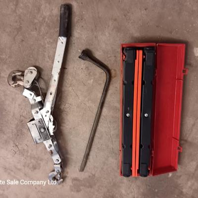 Come a long and tire iron / pry bar with orange safety triangles in a storage box