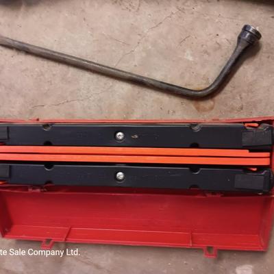 Come a long and tire iron / pry bar with orange safety triangles in a storage box