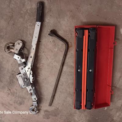 Come a long and tire iron / pry bar with orange safety triangles in a storage box