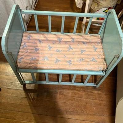 Vintage Amsco Brand Metal Doll crib w bunny and plastic mattress and one side down view