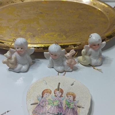 Collection of vintage Angels and a gold-colored oval platter.