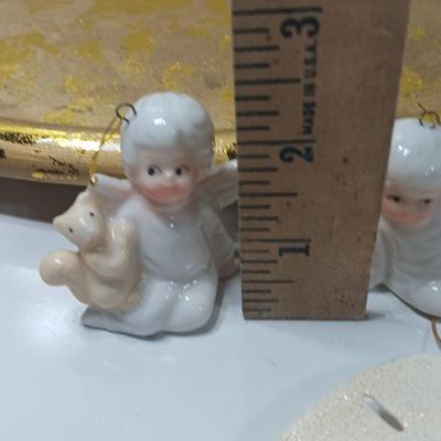 Collection of vintage Angels and a gold-colored oval platter.