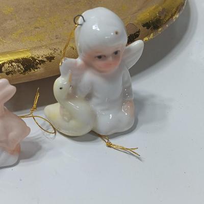 Collection of vintage Angels and a gold-colored oval platter.