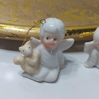 Collection of vintage Angels and a gold-colored oval platter.