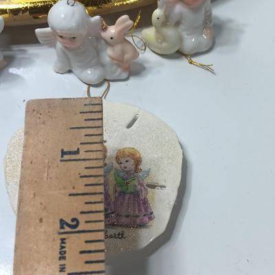 Collection of vintage Angels and a gold-colored oval platter.