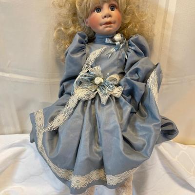 Porcelain doll with cloth body