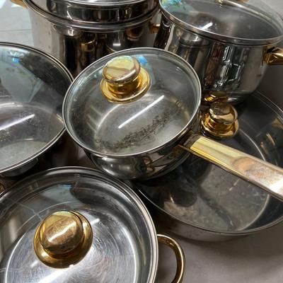 Large set of Pots & Pans Cuisine Cookware with Gold Accent on Knobs.
