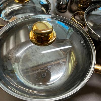 Large set of Pots & Pans Cuisine Cookware with Gold Accent on Knobs.