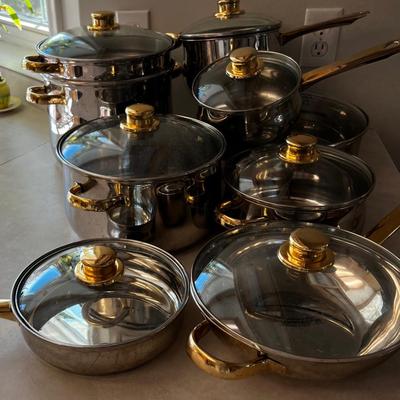 Large set of Pots & Pans Cuisine Cookware with Gold Accent on Knobs.