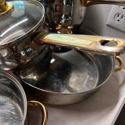 Large set of Pots & Pans Cuisine Cookware with Gold Accent on Knobs.
