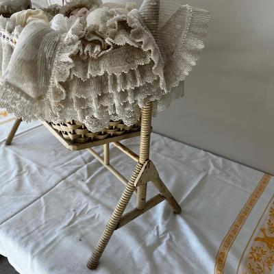 Porcelain Doll in an Antique Swinging Doll Bassinet