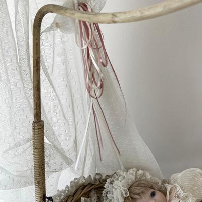 Porcelain Doll in an Antique Swinging Doll Bassinet
