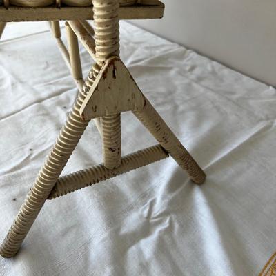 Porcelain Doll in an Antique Swinging Doll Bassinet