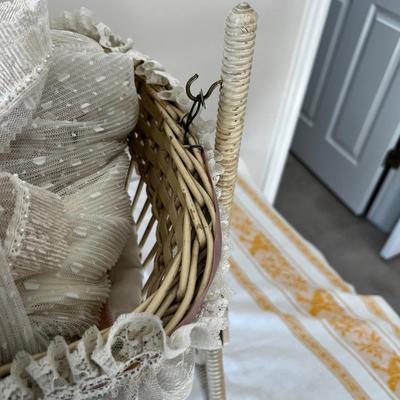 Porcelain Doll in an Antique Swinging Doll Bassinet