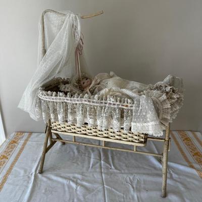 Porcelain Doll in an Antique Swinging Doll Bassinet