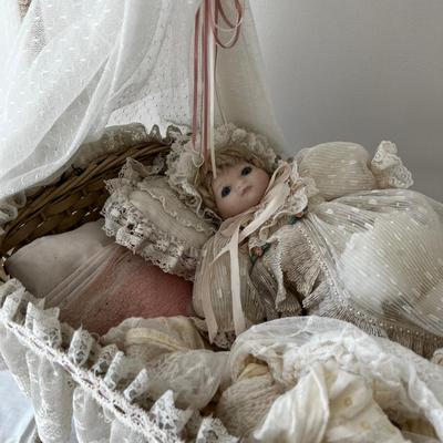 Porcelain Doll in an Antique Swinging Doll Bassinet