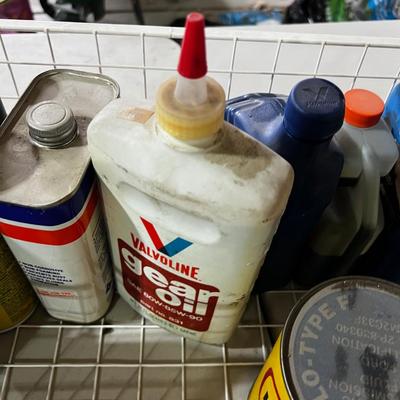 Garage Tray Full of Automotive Fluids, Many opened but some not.