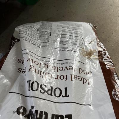 Garage: Potting Soil and Grass Seed - Partial Bags. Opened