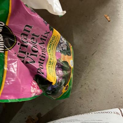 Garage: Potting Soil and Grass Seed - Partial Bags. Opened