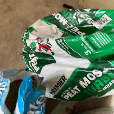 Garage: Potting Soil and Grass Seed - Partial Bags. Opened