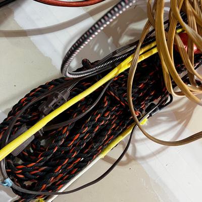 Garage Jumper Cable, Wire, Extension Cords (2 Piles Hanging up) 