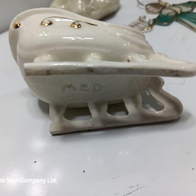 Porcelain angel with white and gold sleigh and blue angel with harp ornament