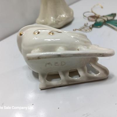 Porcelain angel with white and gold sleigh and blue angel with harp ornament